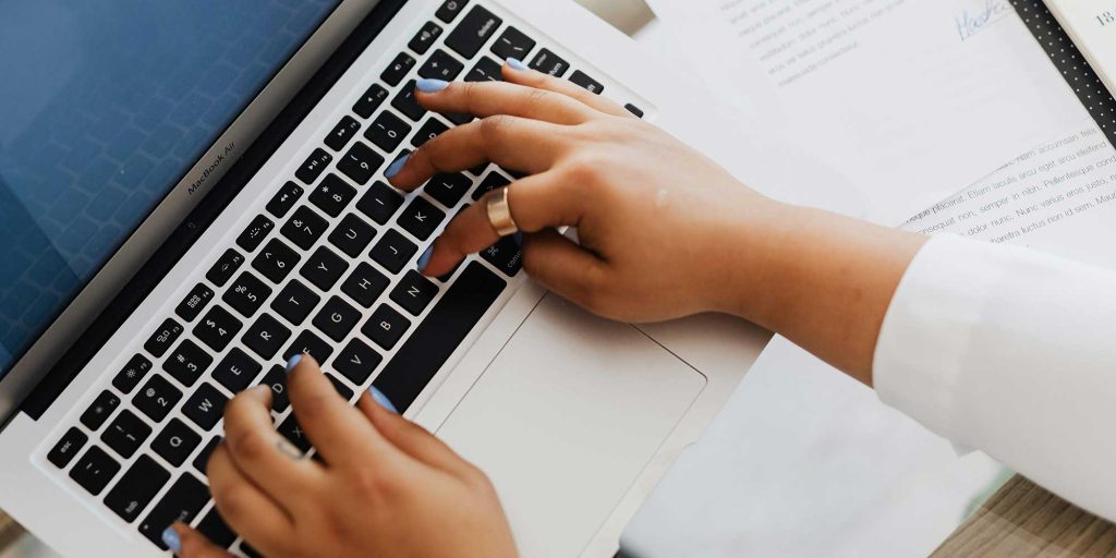 Person with their fingers on a keyboard