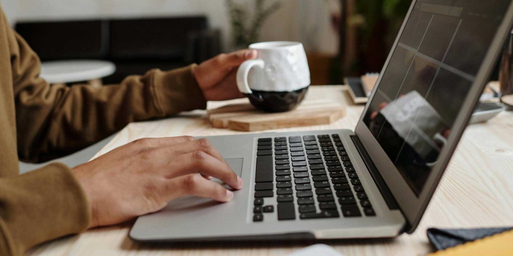 Person with their fingers on a keyboard