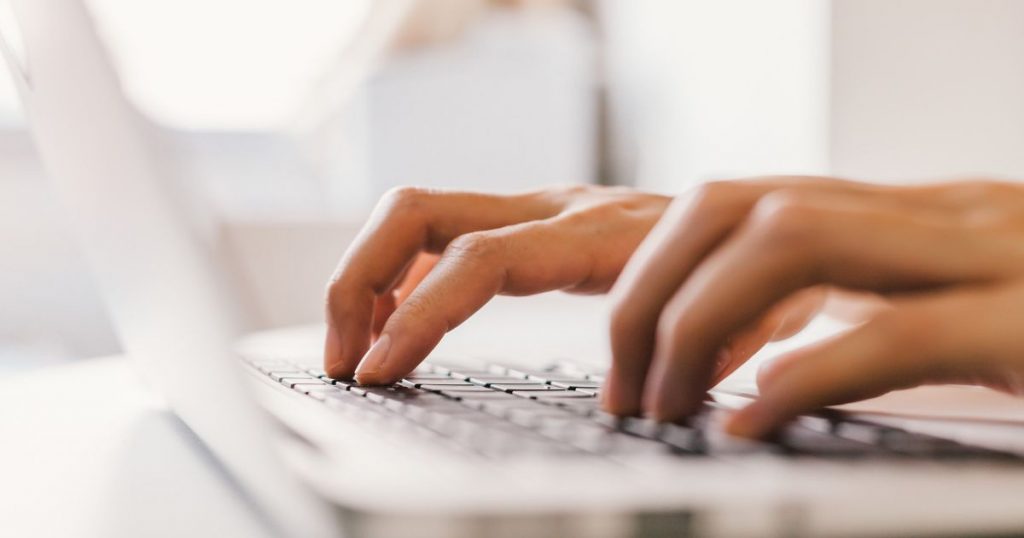 Typing on a laptop