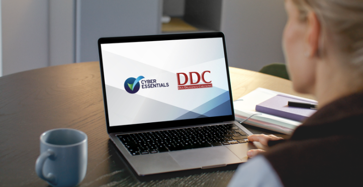 Individual on laptop with DDC and the Cyber Essentials logo